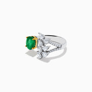 The Brasilica 14K White Gold Emerald and Diamond Ring showcases an oval green emerald in gold prongs on one side and pear-shaped white diamonds in a floral pattern on the other, all crafted in luxurious 14K white gold.