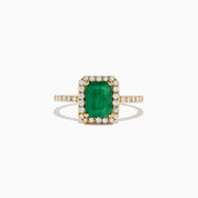 The Brasilica 14K Yellow Gold Emerald and Diamond Ring, 1.69 TCW, showcases a rectangular green emerald center surrounded by a halo of round diamonds with additional diamonds set along the band.