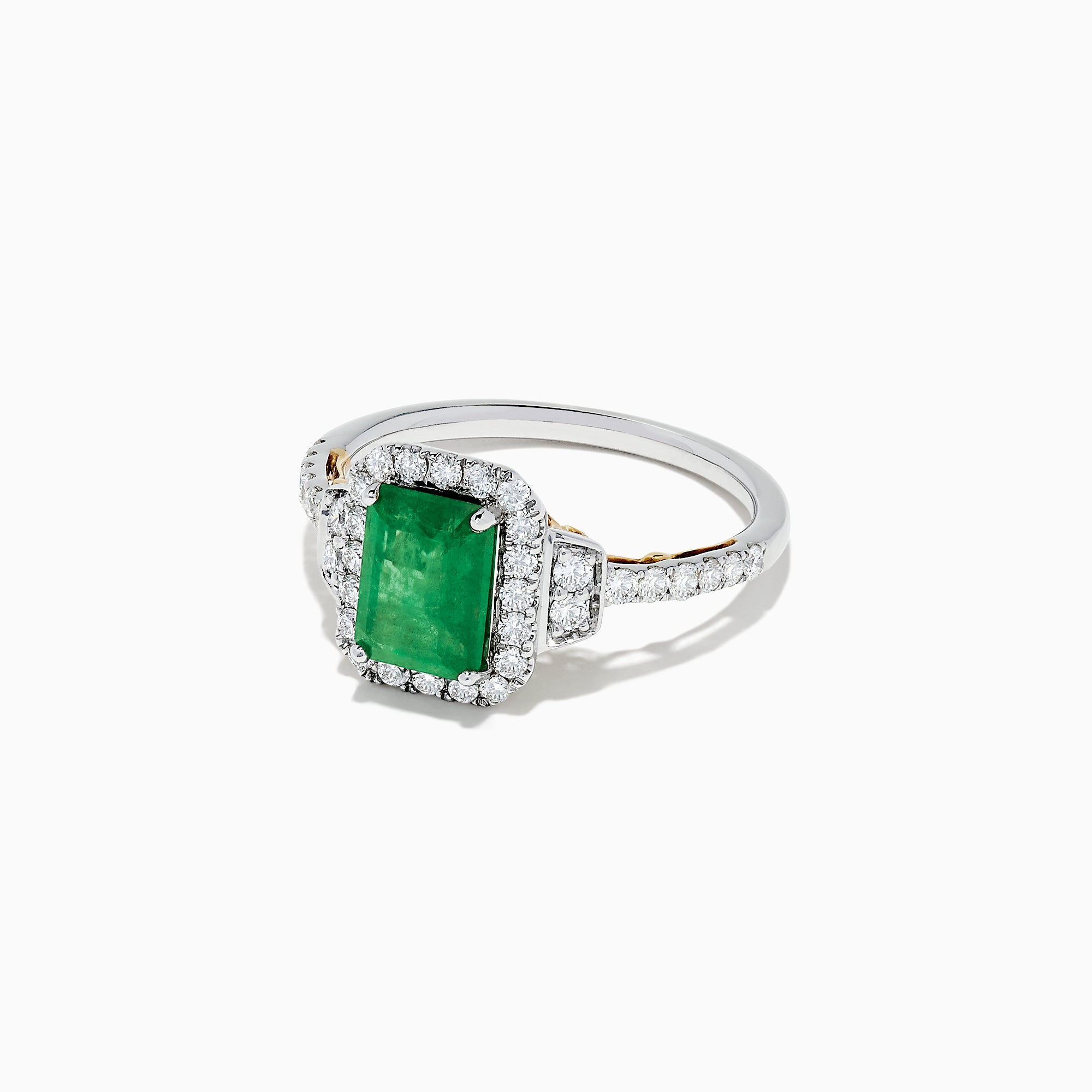 The Brasilica 14K Two Tone Gold Emerald and Diamond Ring, 1.90 TCW, features a striking rectangular emerald center, encircled by round diamonds and further accented with diamonds along the gold band.