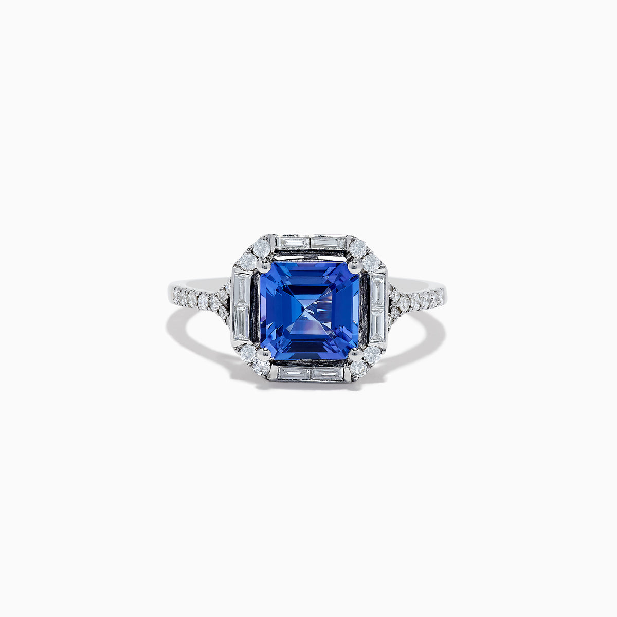 The Nahla Siri 14K White Gold Tanzanite and Diamond Ring showcases a large, square-cut blue tanzanite center with round and baguette-cut diamonds, displayed on a white background.