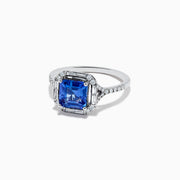 The Nahla Siri 14K White Gold Tanzanite and Diamond Ring showcases a large, square-cut blue tanzanite center with round and baguette-cut diamonds, displayed on a white background.