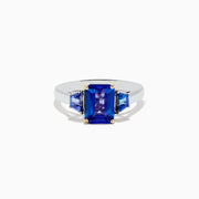 The Nahla Siri 14K Two-Tone Gold Tanzanite Ring showcases a large rectangular blue gemstone with two smaller triangular accents, all in a four-prong setting for a striking effect.