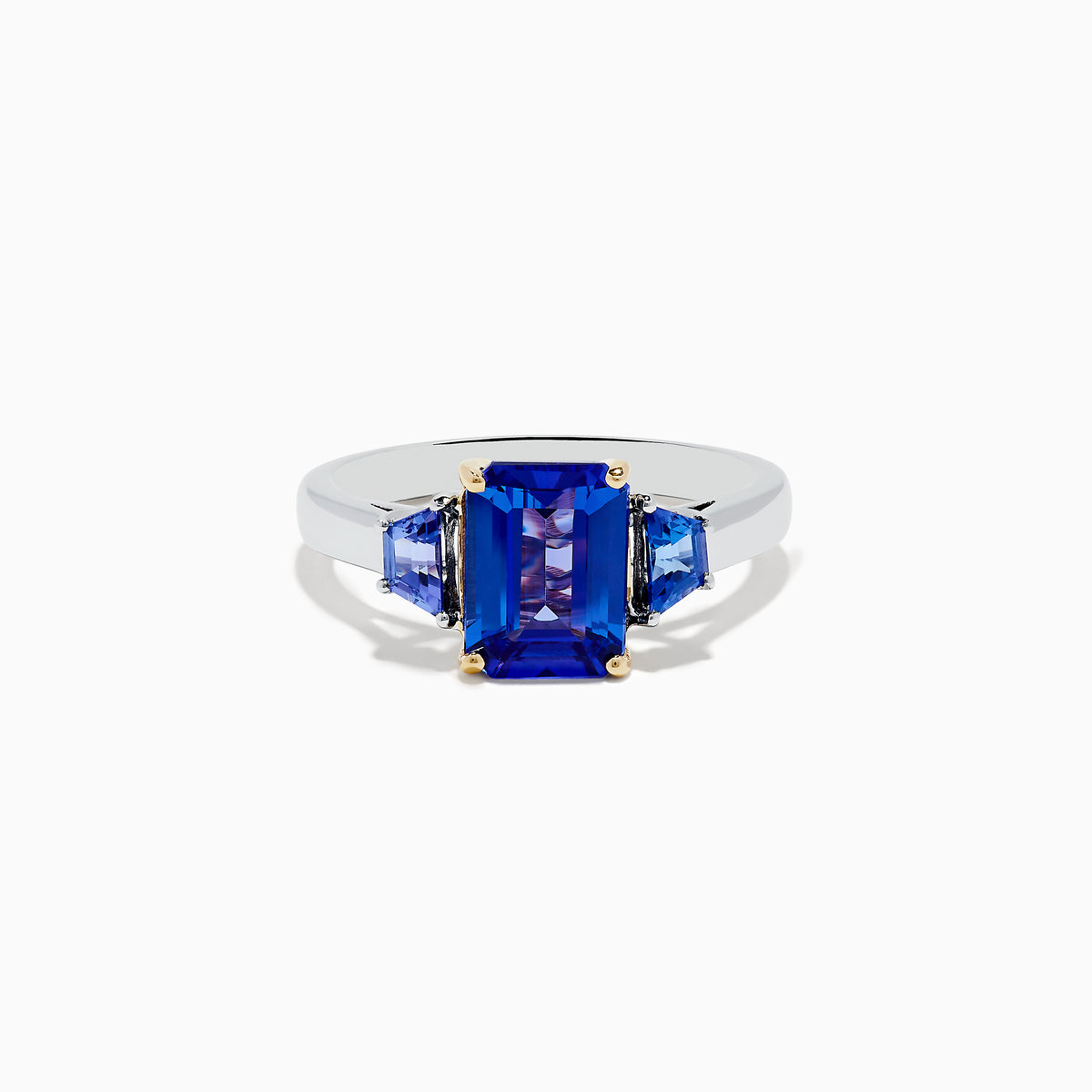 The Nahla Siri 14K Two-Tone Gold Tanzanite Ring showcases a large rectangular blue gemstone with two smaller triangular accents, all in a four-prong setting for a striking effect.