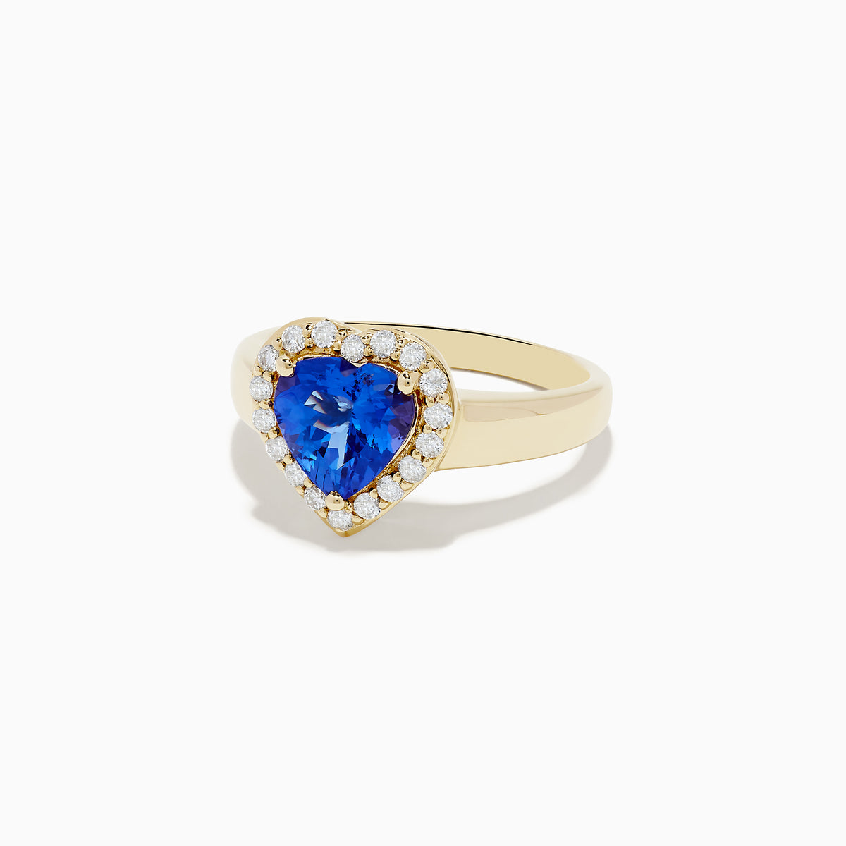 The Nahla Siri 14K Yellow Gold Tanzanite and Diamond Heart Ring, featuring a heart-shaped blue tanzanite surrounded by round white diamonds, is shown against a plain white background.