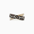 The 14K Yellow Gold Espresso, Black and White Diamond Ring features a crisscross snakeskin-inspired design and rows of sparkling diamonds totaling 0.76 TCW, creating a modern, luxurious look.