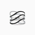 The 14K White Gold White and Black Diamond Crossover Ring features wide, wavy open bands with alternating black and white diamonds in an elegant intertwined pattern.