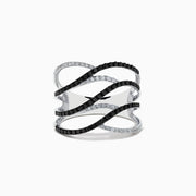 The 14K White Gold White and Black Diamond Crossover Ring features wide, wavy open bands with alternating black and white diamonds in an elegant intertwined pattern.