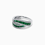 A 14K White Gold Princess Cut Emerald and Diamond Ring, 1.76 TCW, features two overlapping bands with rectangular green emeralds at the center bordered by small diamonds, displayed against a white background.
