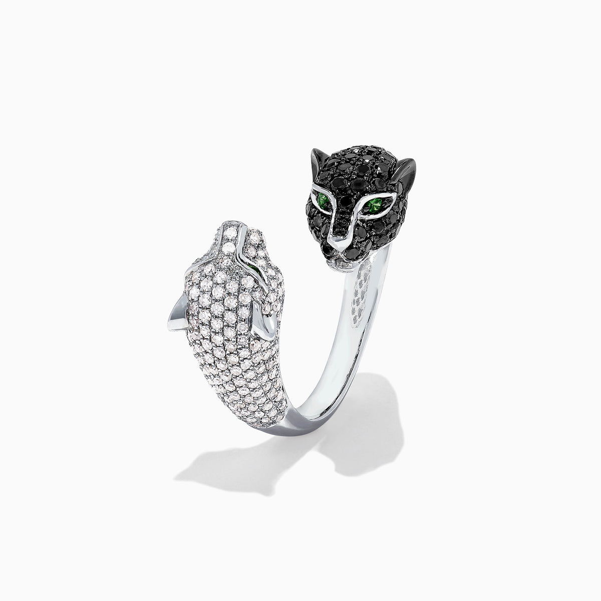 The Signature 14K Gold Black & White Diamond Double Panther Ring, 1.49 TCW, features two panther heads—one with black stones, the other with white—each set with vivid green gemstone eyes.