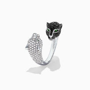 The Signature 14K Gold Black & White Diamond Double Panther Ring, 1.49 TCW, features two panther heads—one with black stones, the other with white—each set with vivid green gemstone eyes.
