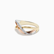 The Trio 14K Three Tone Diamond Cross Over Ring features intertwined yellow, rose, and white gold bands, with one band adorned with sparkling diamonds for a smooth and elegant look.