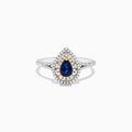 The Royale Bleu 14K Two Tone Gold Sapphire and Diamond Ring, 0.77 TCW, features a pear-shaped sapphire center with double diamond halos, gold accents, and a diamond-adorned band.