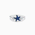 The Seaside 14K White Gold Sapphire and Diamond Starfish Ring showcases a blue sapphire and diamond starfish center, accented by two small clear gemstone fish shapes on each side, all set in white gold.