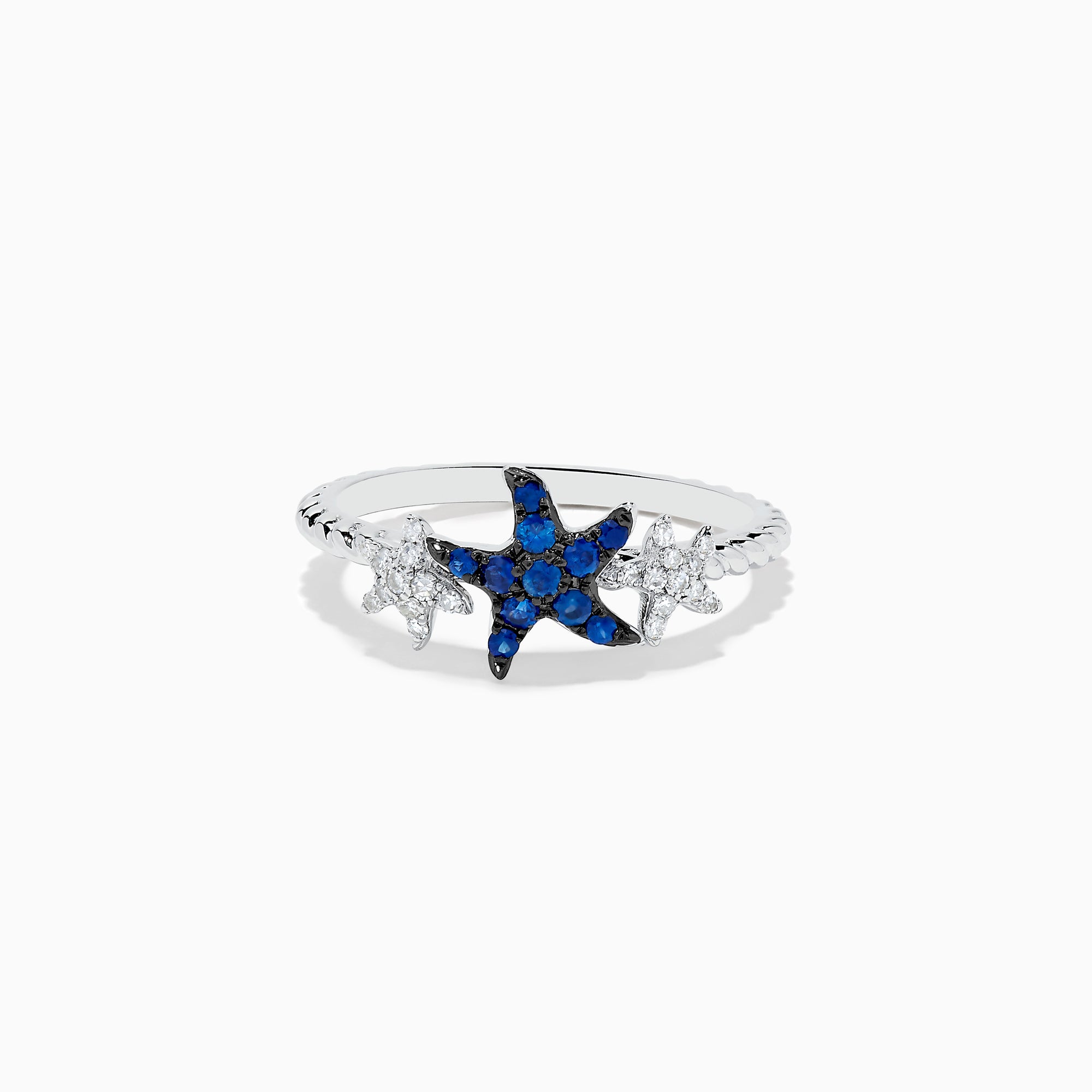 The Seaside 14K White Gold Sapphire and Diamond Starfish Ring showcases a blue sapphire and diamond starfish center, accented by two small clear gemstone fish shapes on each side, all set in white gold.