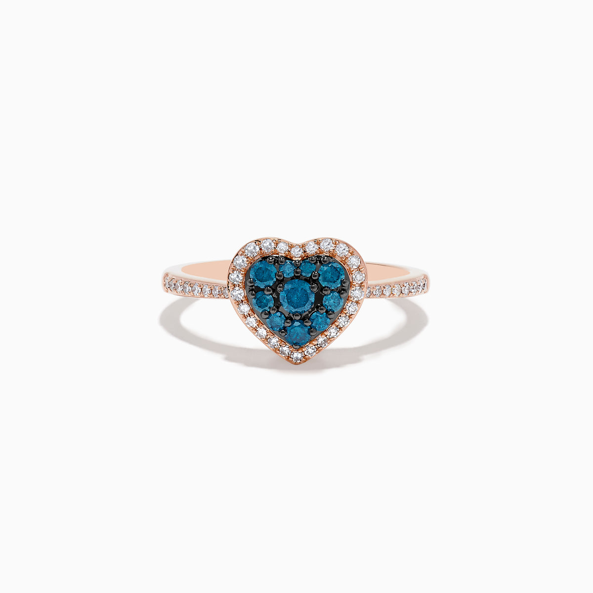 The Bella Bleu 14K Rose Gold Blue and White Diamond Heart Ring features a heart-shaped cluster of blue and white diamonds, accented by a border of clear stones and more clear stones set on the band.