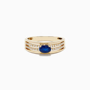 The Royale Bleu 14K Yellow Gold Sapphire and Diamond Ring features a central oval blue sapphire accented by two rows of sparkling round diamonds on each side, beautifully set against a white gold background.