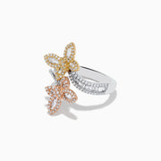 The Trio 14K Three-Tone Gold Diamond Butterfly Bypass Ring features diamond accents, overlapping butterfly shapes, and a curved, diamond-encrusted three-tone gold band on a white background.