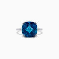 The Ocean Bleu 14K White Gold London Blue Topaz and Diamond Ring, 8.40 TCW, showcases a large cushion-cut London Blue Topaz center with four prongs and round diamonds set along the band.