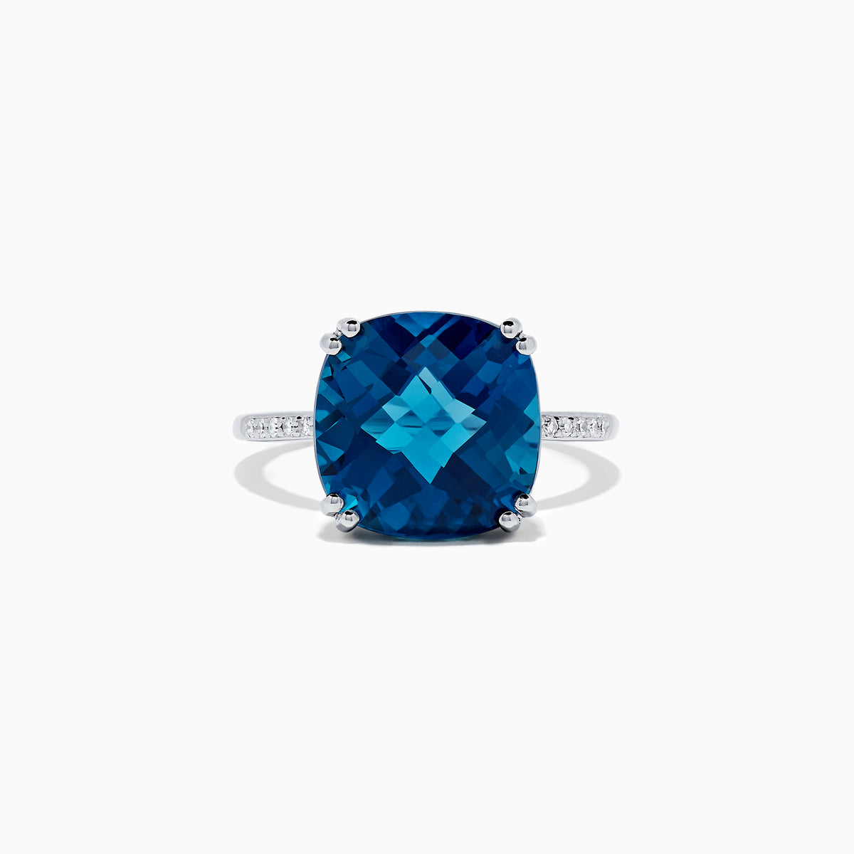The Ocean Bleu 14K White Gold London Blue Topaz and Diamond Ring, 8.40 TCW, showcases a large cushion-cut London Blue Topaz center with four prongs and round diamonds set along the band.