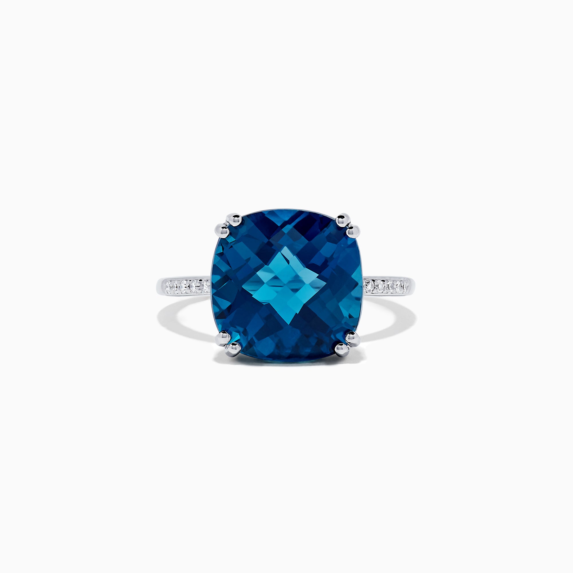 The Ocean Bleu 14K White Gold London Blue Topaz and Diamond Ring, 8.40 TCW, showcases a large cushion-cut London Blue Topaz center with four prongs and round diamonds set along the band.