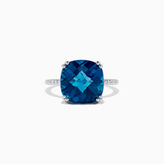 The Ocean Bleu 14K White Gold London Blue Topaz and Diamond Ring, 8.40 TCW, showcases a large cushion-cut London Blue Topaz center with four prongs and round diamonds set along the band.