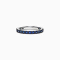 The Royale Bleu 14K White Gold Blue Sapphire Band Ring, 0.99 TCW, features a row of small round blue sapphires set all around a white gold band and is displayed on a plain white background.