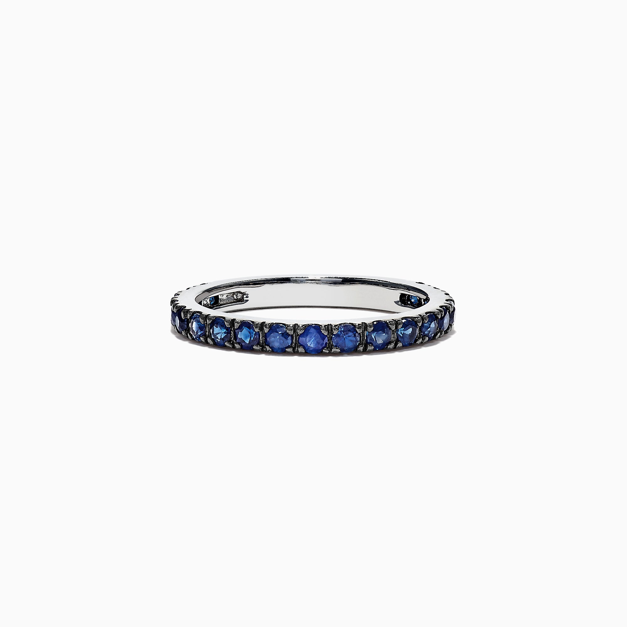 The Royale Bleu 14K White Gold Blue Sapphire Band Ring, 0.99 TCW, features a row of small round blue sapphires set all around a white gold band and is displayed on a plain white background.