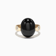A Limited Edition Men’s 14K Yellow Gold Onyx and Diamond Ring, 15.49 TCW, features a large smooth black onyx centerpiece flanked by small round diamonds, shown against a plain white background.