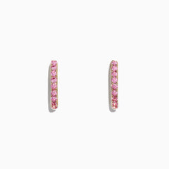 A pair of 14K yellow gold huggie hoop earrings, set with pink sapphires totaling 0.86 TCW, displayed against a white background.