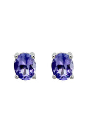 A pair of 14K white gold oval tanzanite stud earrings, 0.65 TCW, shown on a white background.